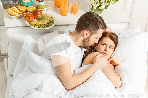 Image of Relaxed Couple in Bed in bedroom at home