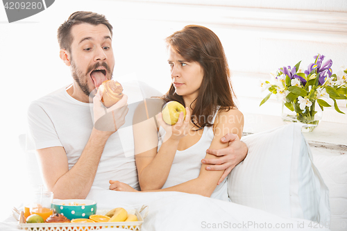 Image of Relaxed Couple in Bed in bedroom at home