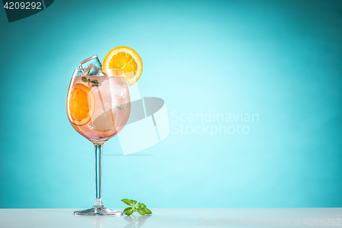 Image of The rose exotic cocktail and fruit on blue