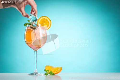 Image of The rose exotic cocktail and fruit on blue