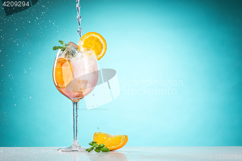 Image of The rose exotic cocktail and fruit on blue