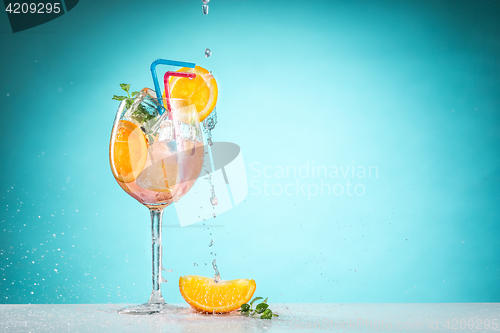 Image of The rose exotic cocktail and fruit on blue