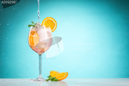 Image of The rose exotic cocktail and fruit on blue