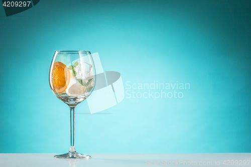 Image of The rose exotic cocktail and fruit on blue