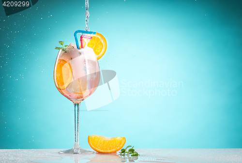 Image of The rose exotic cocktail and fruit on blue