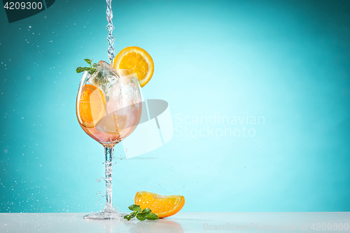 Image of The rose exotic cocktail and fruit on blue