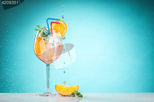 Image of The rose exotic cocktail and fruit on blue