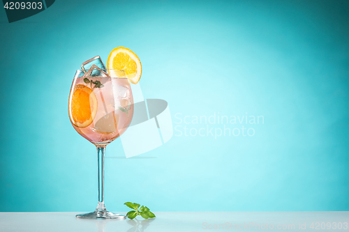 Image of The rose exotic cocktail and fruit on blue