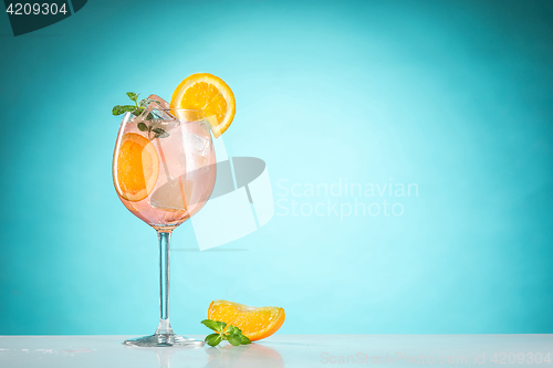 Image of The rose exotic cocktail and fruit on blue