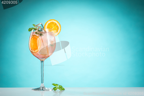 Image of The rose exotic cocktail and fruit on blue