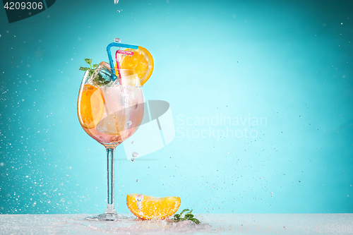 Image of The rose exotic cocktail and fruit on blue