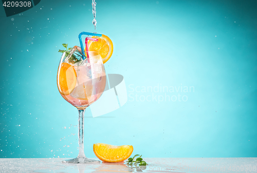 Image of The rose exotic cocktail and fruit on blue