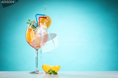 Image of The rose exotic cocktail and fruit on blue