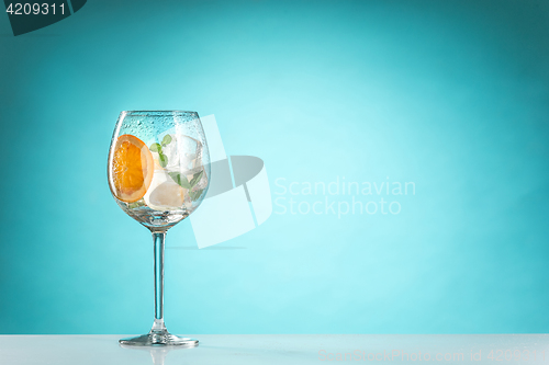 Image of The rose exotic cocktail and fruit on blue