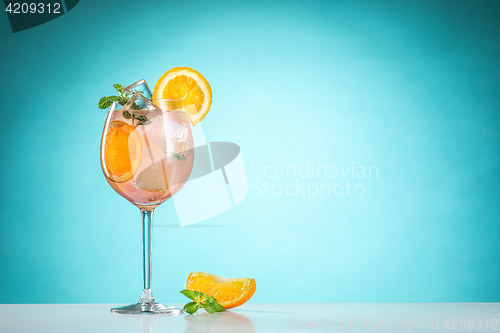 Image of The rose exotic cocktail and fruit on blue