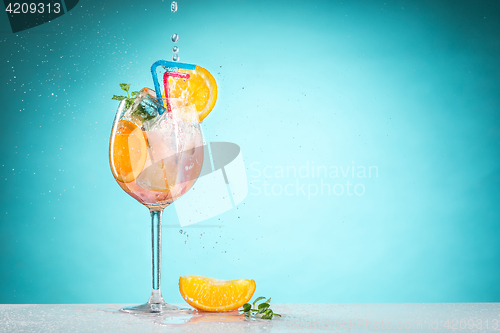 Image of The rose exotic cocktail and fruit on blue