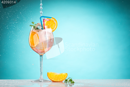 Image of The rose exotic cocktail and fruit on blue