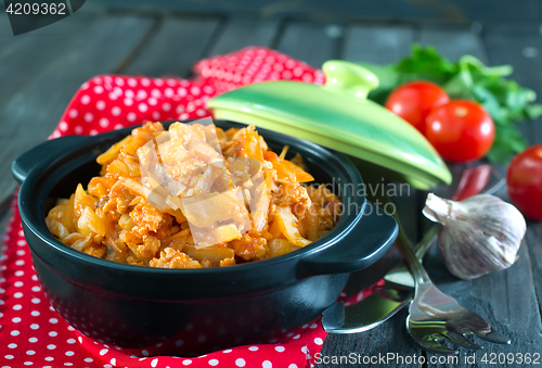 Image of fried cabbage in bowl and on a table