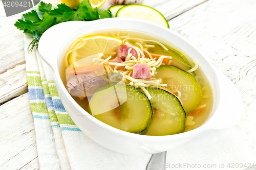 Image of Soup with zucchini and noodles on light board