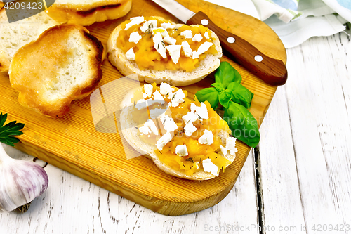 Image of Bruschetta with pumpkin feta on board