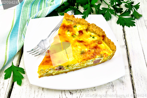 Image of Quiche with pumpkin and bacon in white plate on table
