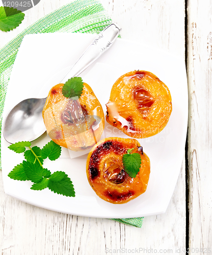 Image of Quince baked with mint in plate on board top