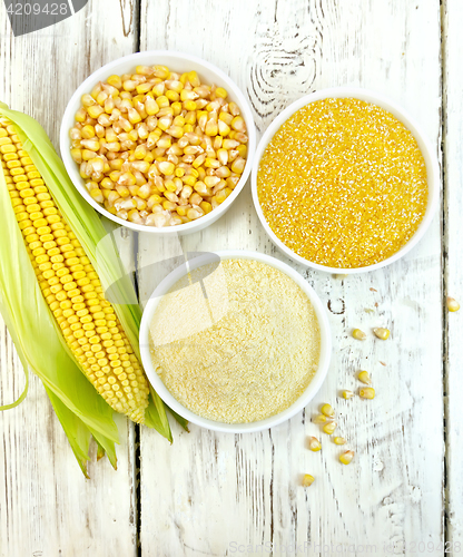 Image of Flour and grits corn in bowls with cobs on board top