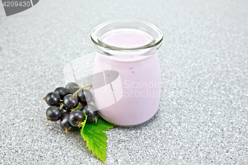 Image of Milk cocktail with black currant in jar on granite table