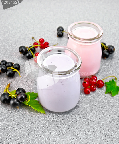 Image of Milk cocktail with black and red currant on granite table