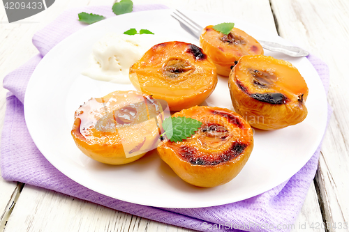 Image of Quince baked with ice-cream in plate on board