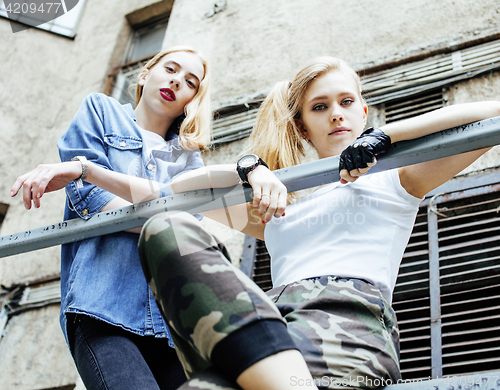 Image of two cool blond real girls friends making selfie on roof top, lif