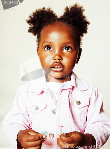 Image of little cute african american girl playing with animal toys at ho