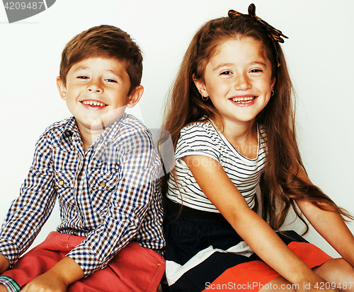 Image of little cute boy and girl hugging playing on white background, ha