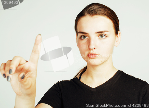 Image of young pretty girl pointing on white background, business science
