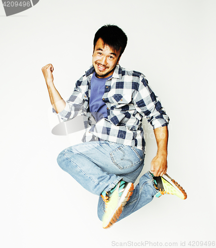 Image of young pretty asian man jumping cheerful against white background