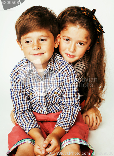 Image of little cute boy and girl hugging playing on white background, ha