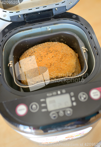 Image of Bread machine and fresh bread at home