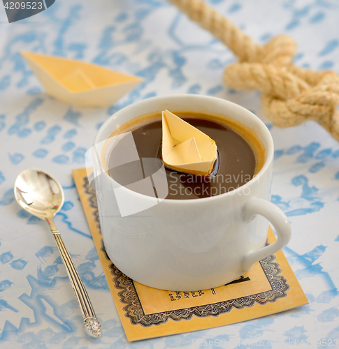 Image of coffee cup and paper boat