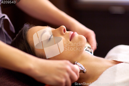 Image of woman having hydradermie facial treatment in spa