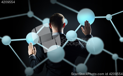 Image of businessman touching virtual screen