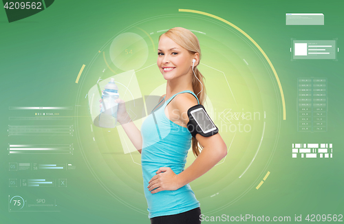 Image of woman with earphones and smartphone doing sports