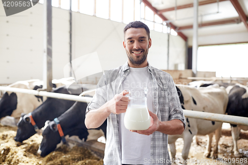 Image of man or farmer with cows milk on dairy farm