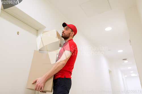 Image of delivery man with parcel boxes at customer door