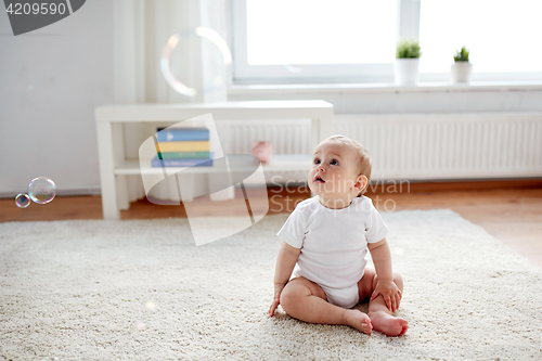 Image of happy baby with soap bubbles at home