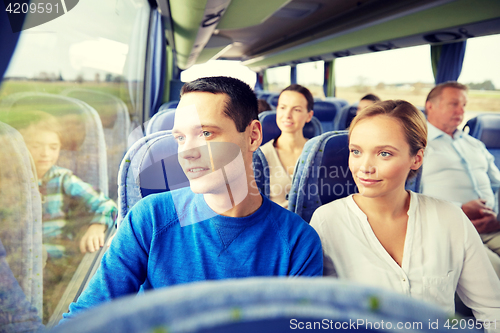 Image of happy couple or passengers in travel bus