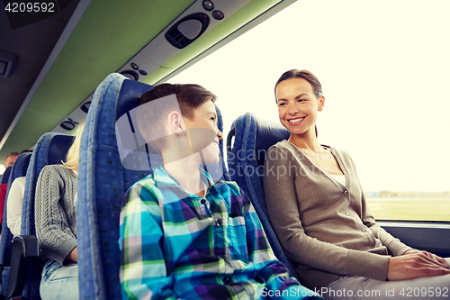 Image of happy family riding in travel bus