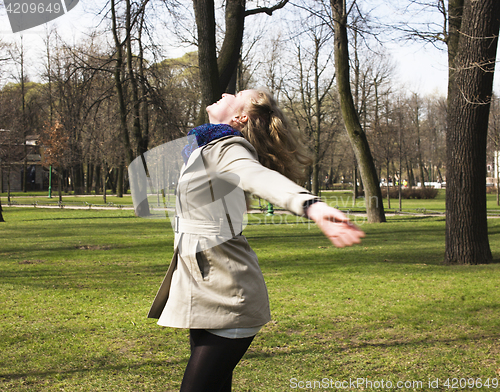 Image of young pretty blonde girl engoing spring nature in park, lifestyle epople concept