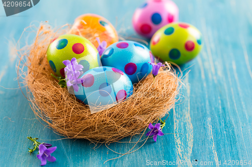 Image of Colorful Easter eggs with spring flowers