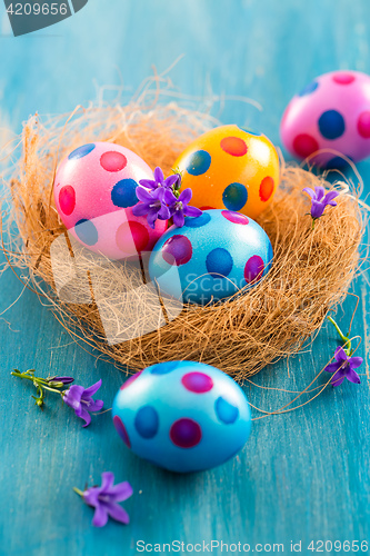 Image of Colorful Easter eggs with spring flowers