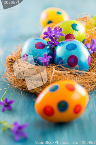 Image of Colorful Easter eggs with spring flowers